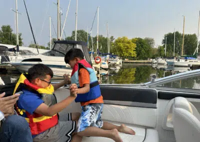 Children enjoy playful moments on the boat as it navigates through Cooks Bay en route to Lake Simcoe. Their laughter and excitement fill the air as they take in the scenic views and create cherished memories of boating adventures amidst the tranquil waters of Gilford, Ontario.